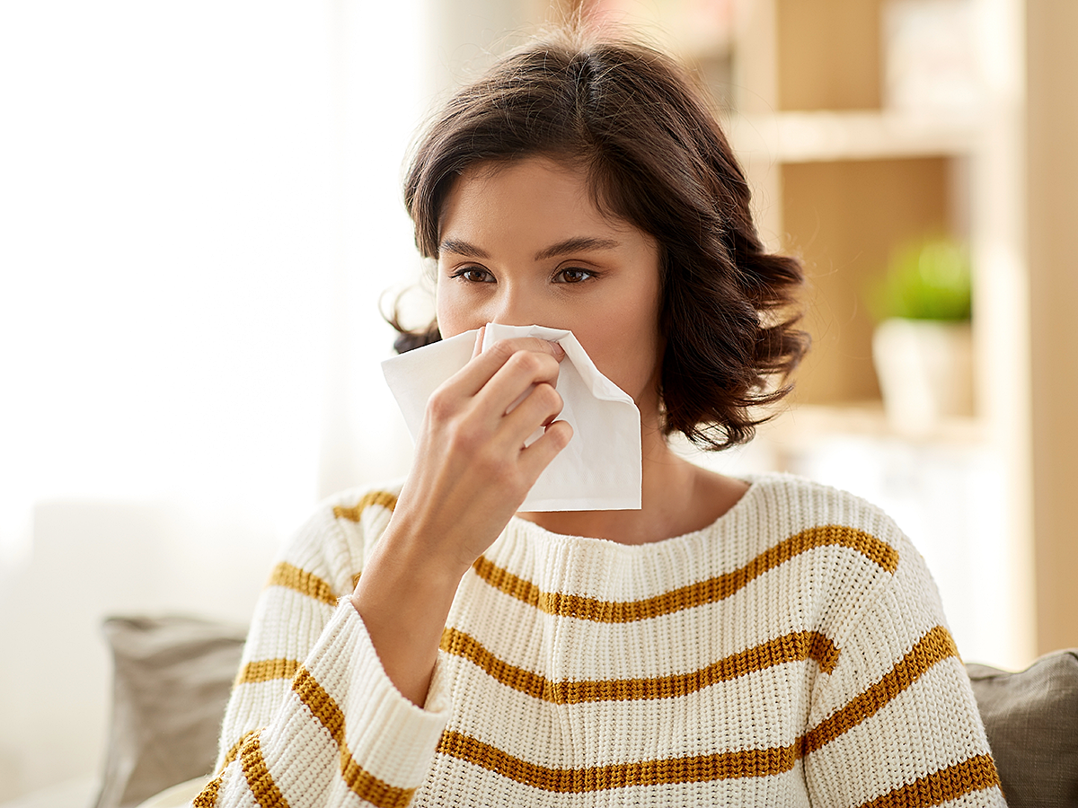 allergies sneezing woman indoors